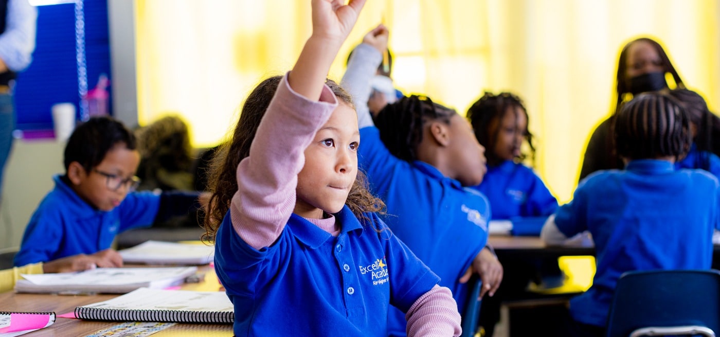 student raising hand in classroom