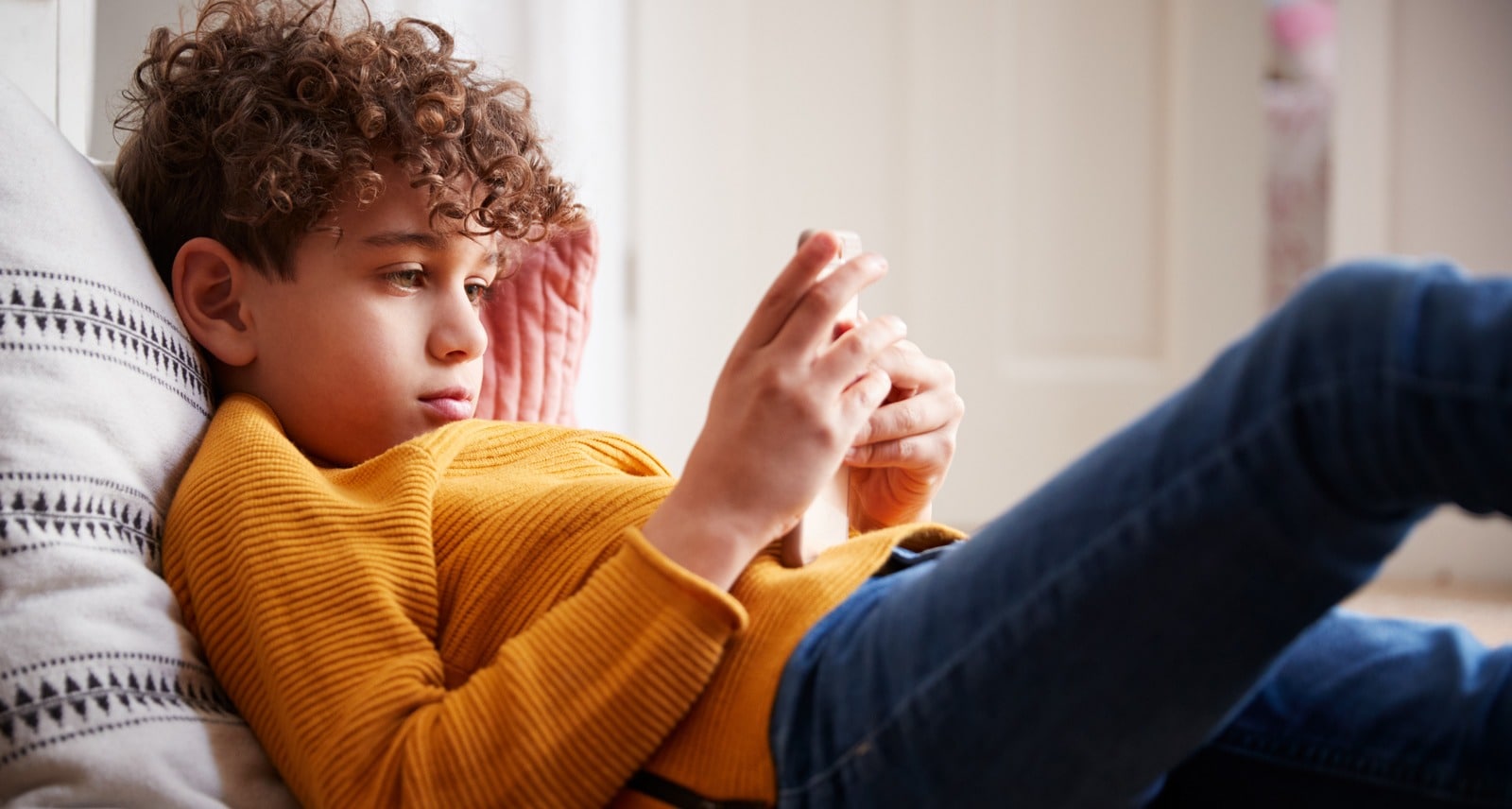 young boy looking at smartphone