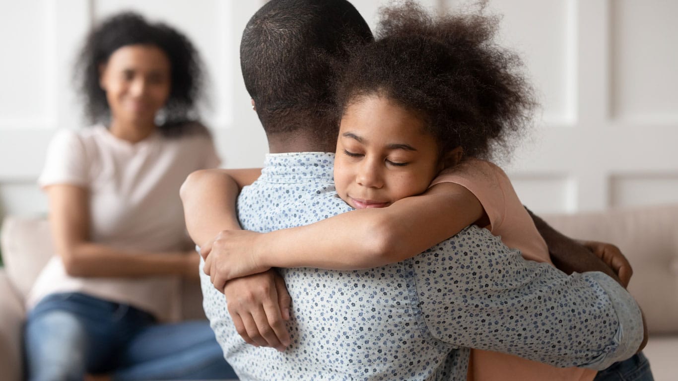 photo of parent hugging child