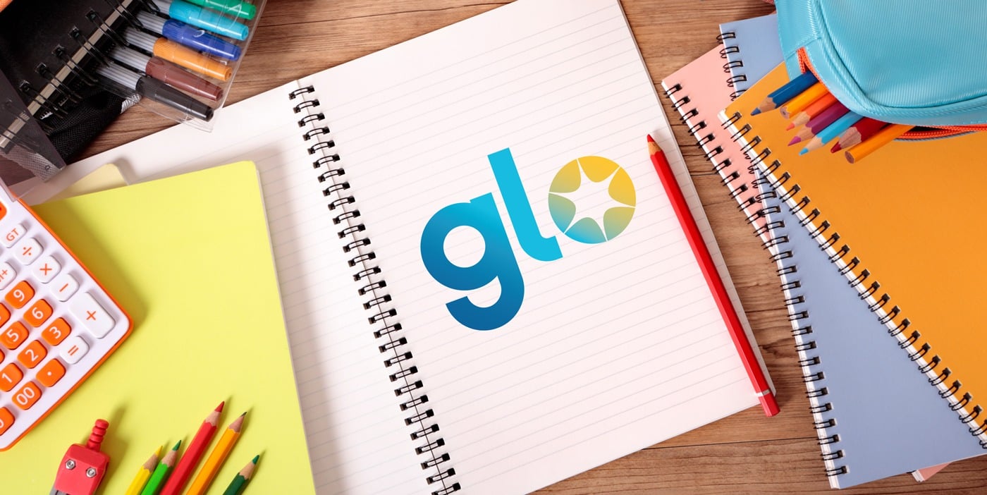 desk with school supplies and glo logo