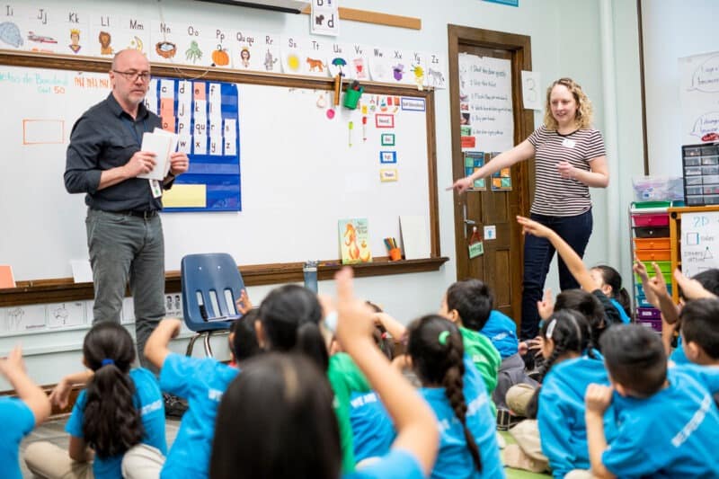 classroom with 2 teachers and students