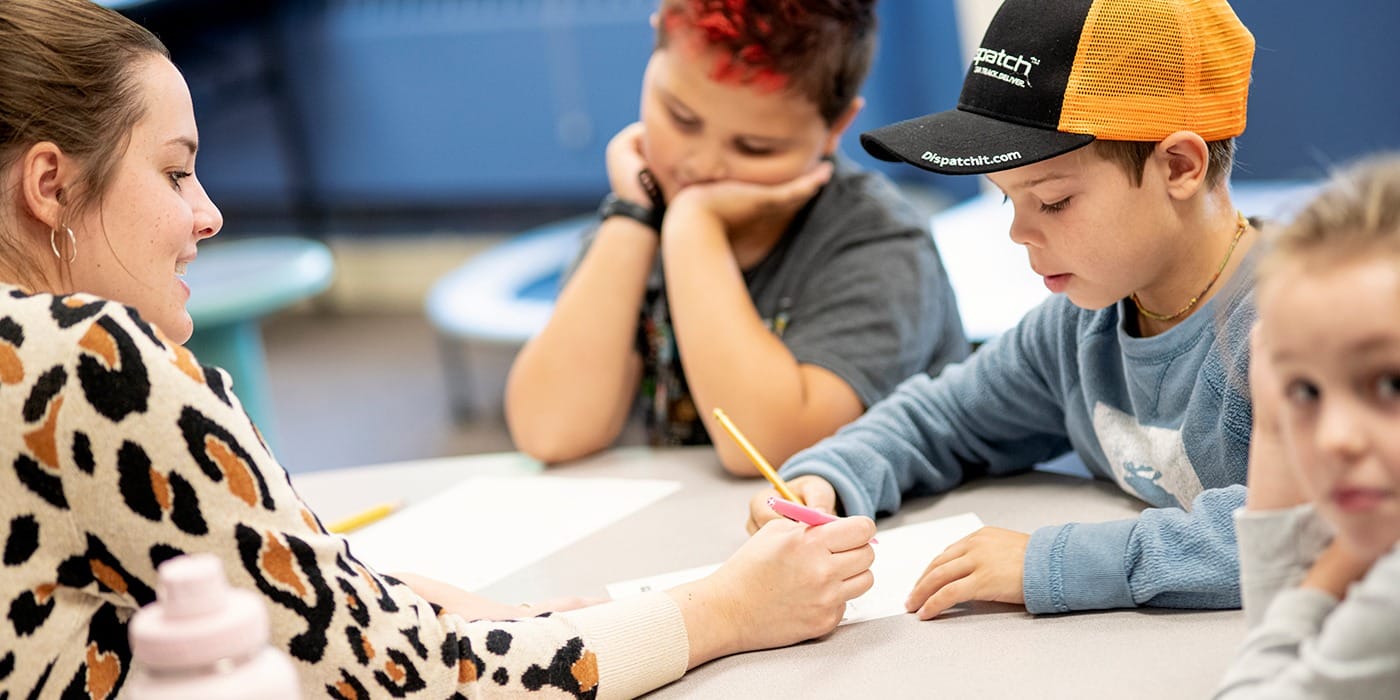 teacher helping students