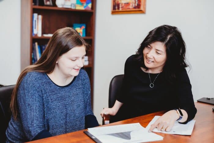 A parent and staff psychologist sit at a desk and review the results of a recent diagnostic learning assessment at the Groves Academy Learning Center.