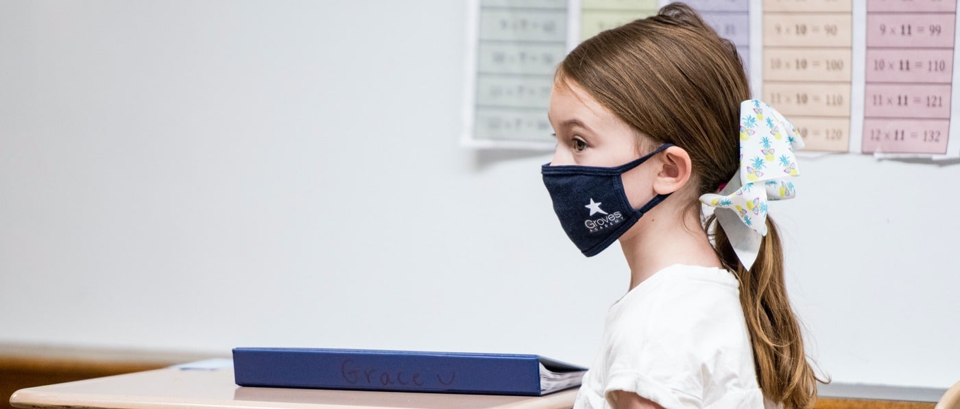 A third-grade student with learning challenges at Groves Academy. She is masked for the in-person part of her hybrid winter semester.