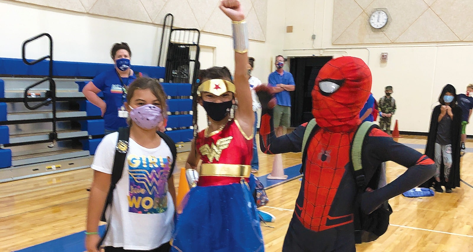 3 kids in costume wearing masks