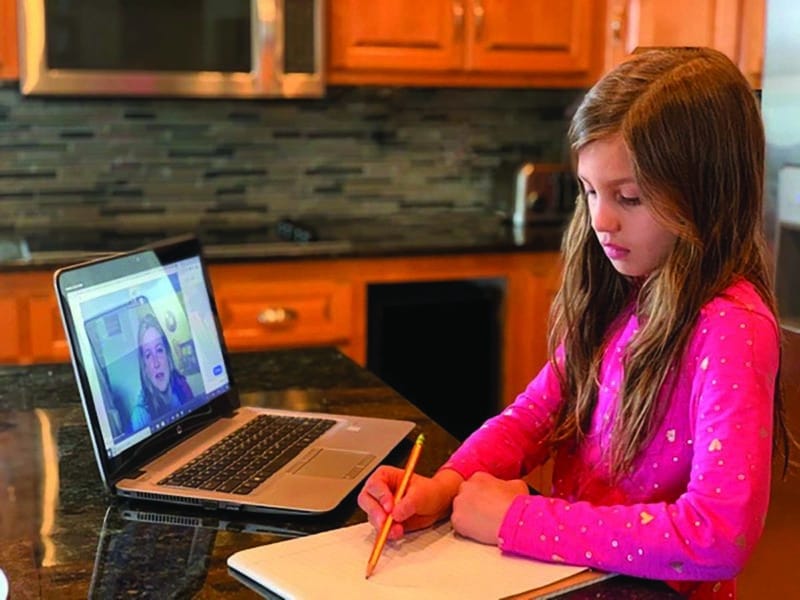 student in virtual session at home computer