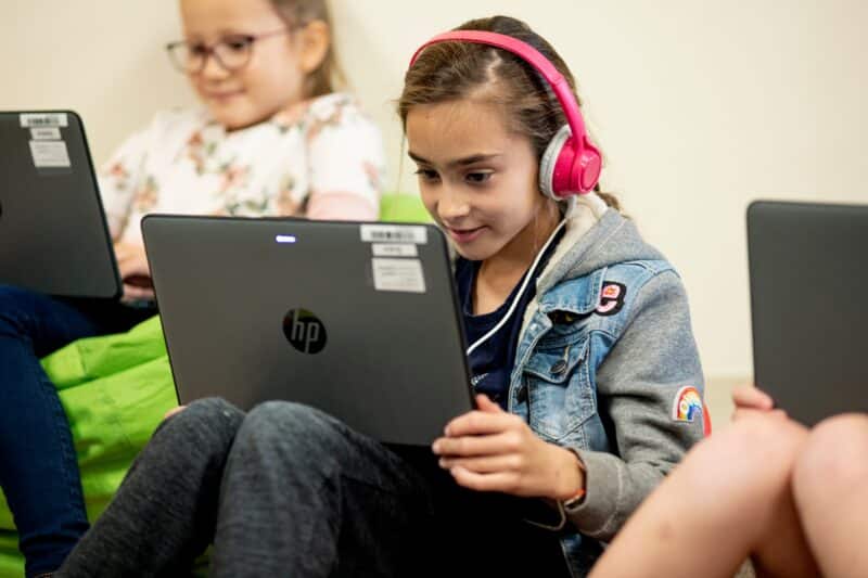 girl wearing headphones looking at screen