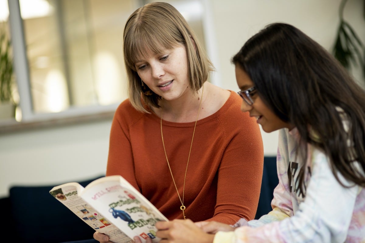 A Groves Academy tutor gives individual reading help to a sixth-grader in The Learning Center.